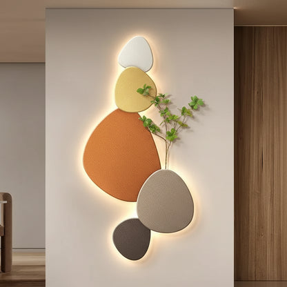 Modern wall art with geometric shapes and lighting in a room setting