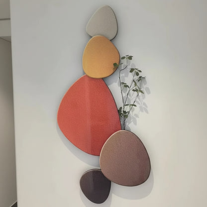 Colorful abstract wall art with geometric shapes on a plain background
